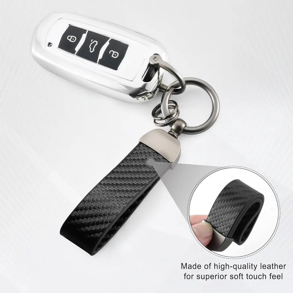 Hand holding JUSTTOP Leather Keychain, showing leather and carbon fiber texture, inside a car