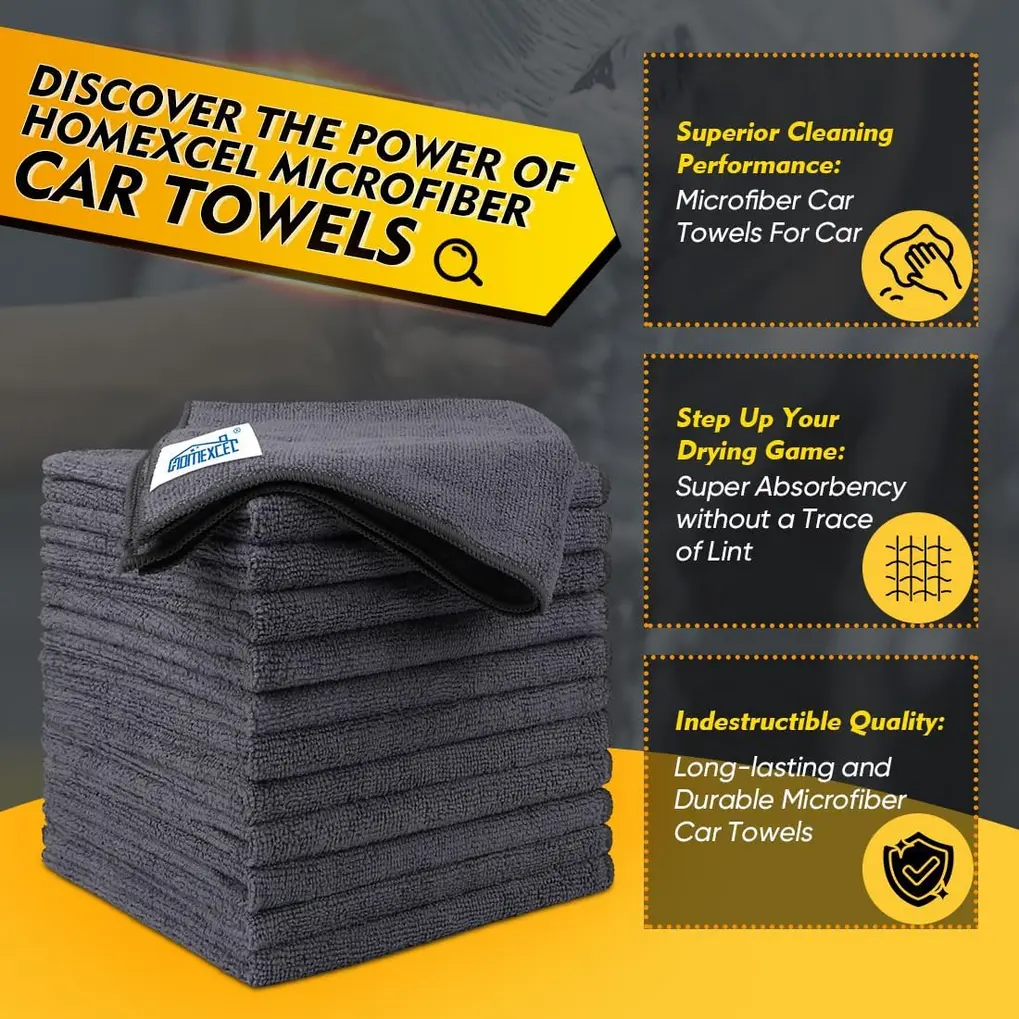 Grey microfiber cleaning cloth wiping a car windshield leaving a clear streak-free area