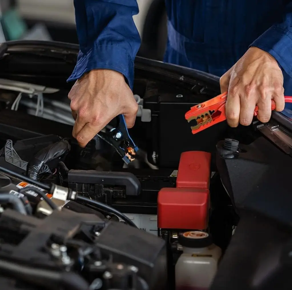 Energizer Jumper Cables laid out between two cars on a driveway