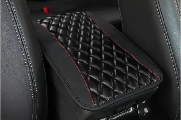 Moly Magnolia Car Center Console Cushion Pad installed on a car's center console, showing its black leather texture.