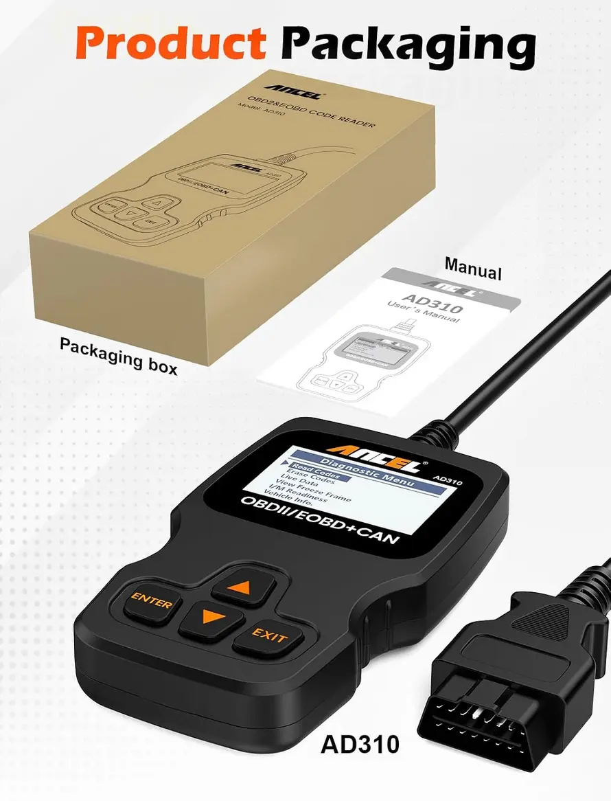 ANCEL AD310 OBD2 scanner and user manual on a workshop bench