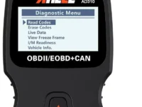 ANCEL AD310 OBD2 scanner connected to a car's OBDII port with a clear screen display