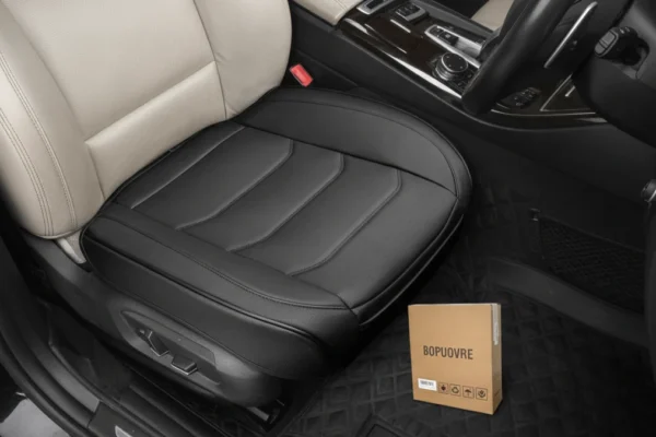 A BOPUOVRE Car Seat Cover in black, installed in a car, with its box nearby.