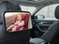 Shynerk Baby Car Mirror mounted on a car seat headrest.